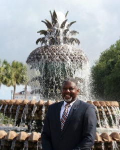 Student Adonis Riley with fountain in the background